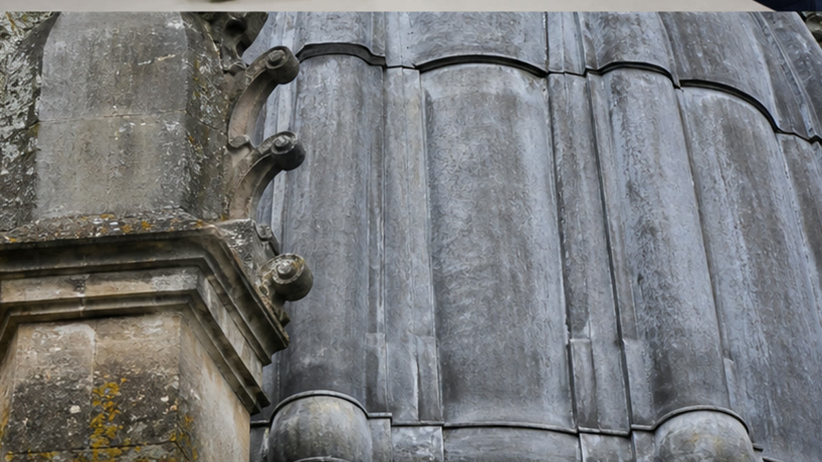 Weathered traditional lead roof bays on a historic building